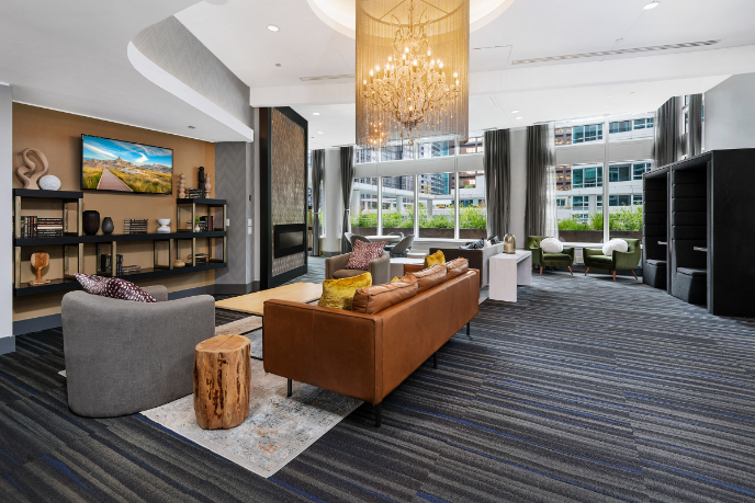Wide angle of the resident lounge decorated with comfortable couches and table sets.